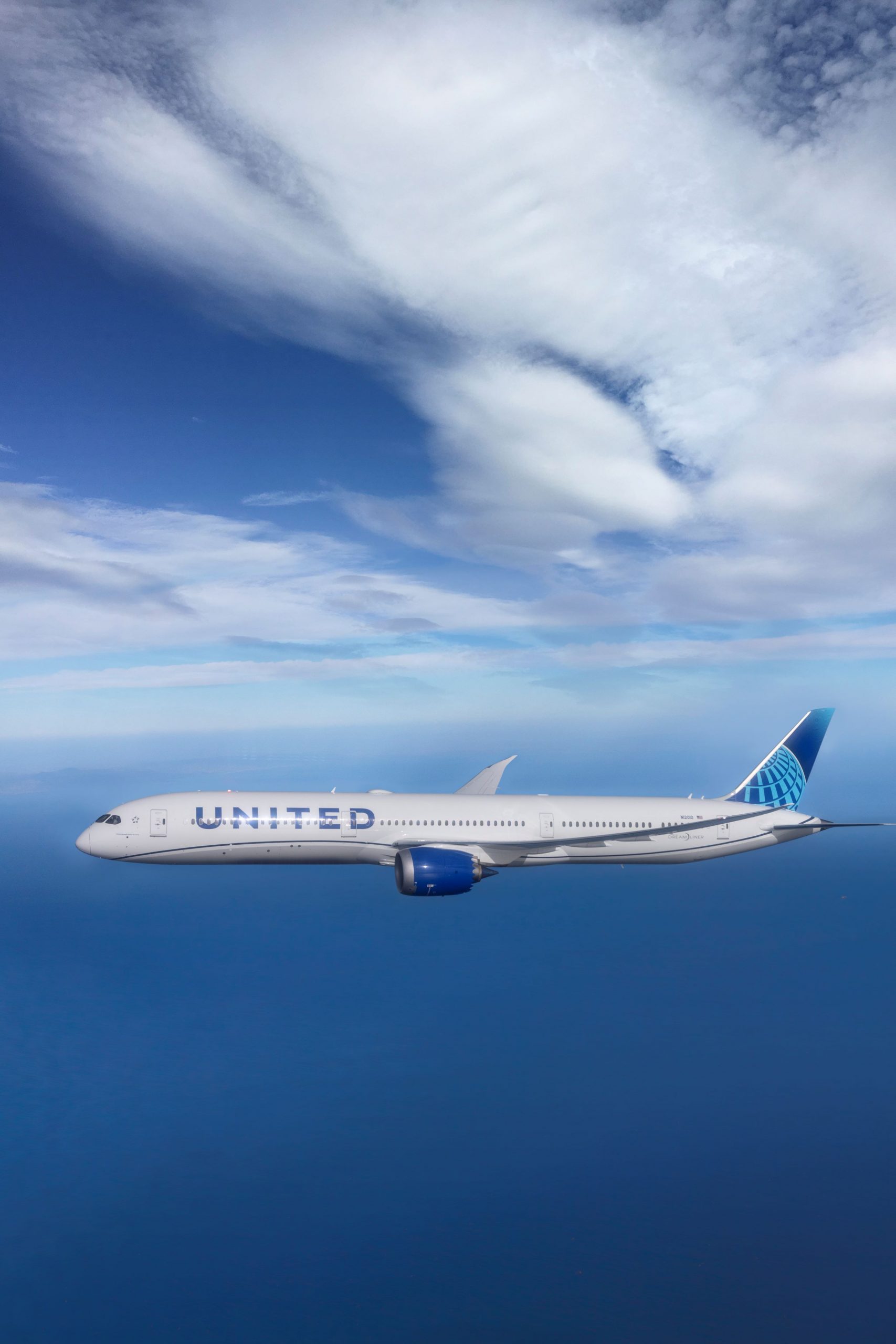 United Airlines plane flying over ocean